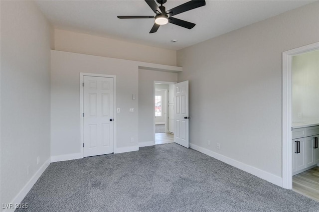 unfurnished bedroom with ceiling fan, light colored carpet, and connected bathroom