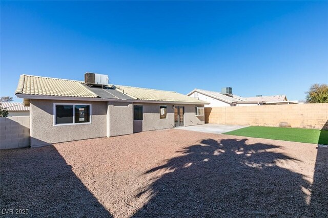 back of house with a patio area and central air condition unit