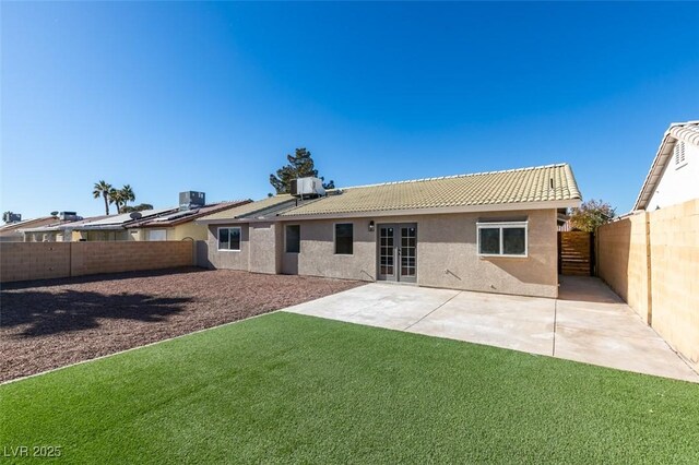 back of property featuring a patio area, central AC unit, and a lawn