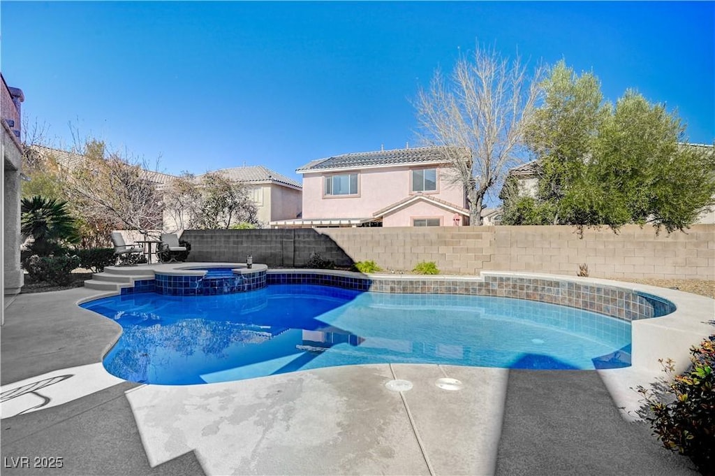 view of pool with an in ground hot tub