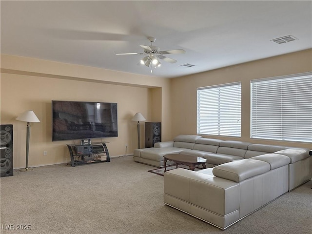 living room featuring ceiling fan and carpet flooring