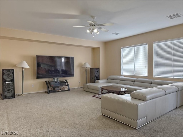 living room with ceiling fan and carpet floors