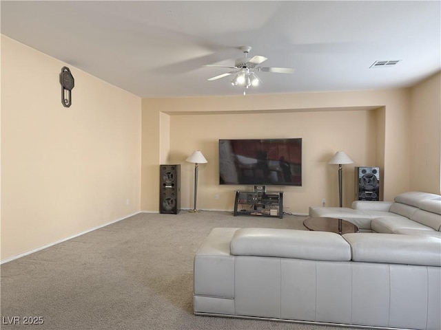 carpeted living room with ceiling fan