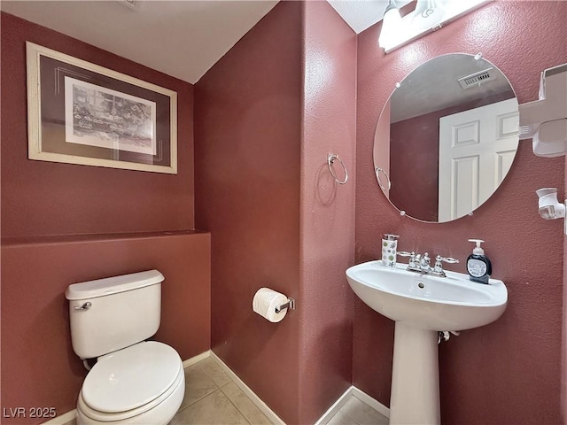 bathroom featuring tile patterned floors and toilet