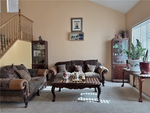 living room with lofted ceiling and carpet flooring