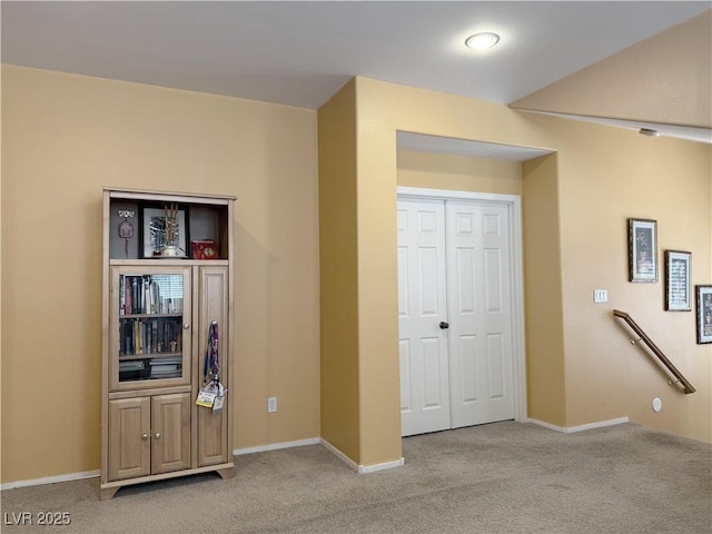 bedroom with a closet and light colored carpet