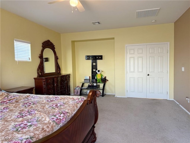 bedroom with light carpet, ceiling fan, and a closet