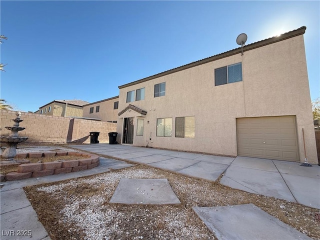 rear view of property with a garage