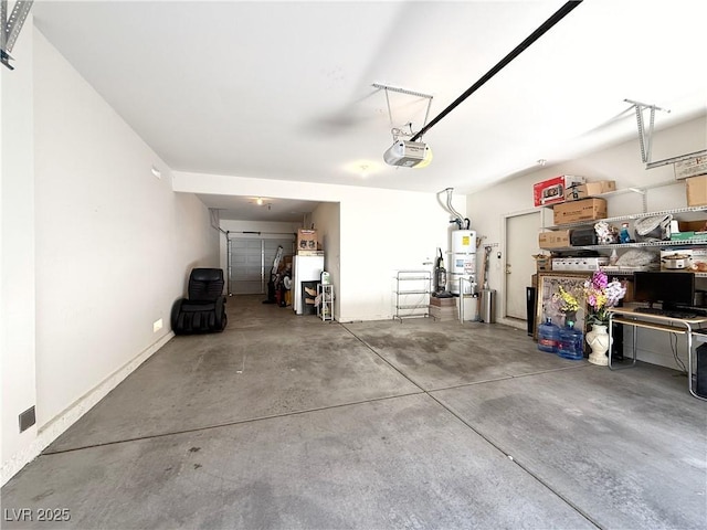 garage featuring a garage door opener and strapped water heater