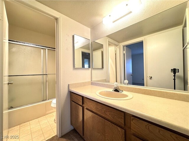 full bathroom featuring toilet, enclosed tub / shower combo, vanity, and a textured ceiling