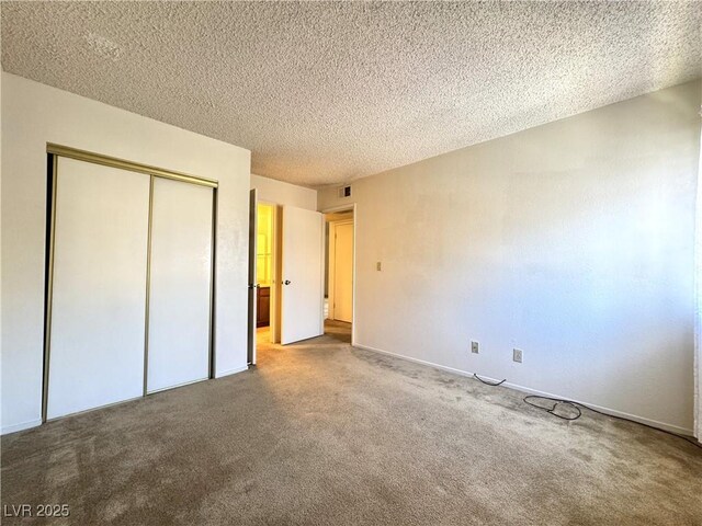 unfurnished bedroom with a closet, a textured ceiling, and carpet flooring