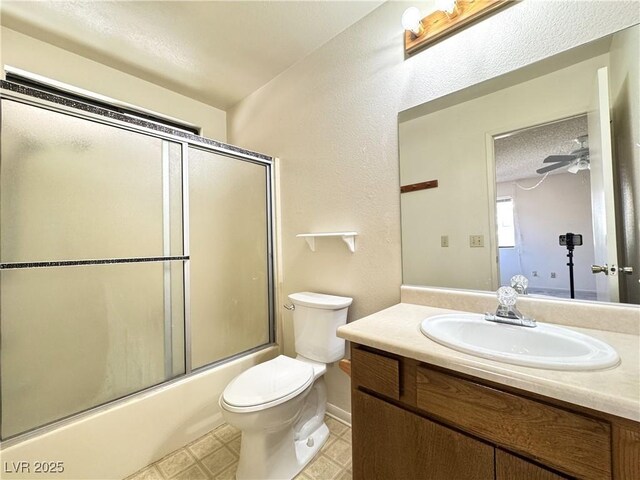 full bathroom featuring toilet, vanity, ceiling fan, and combined bath / shower with glass door