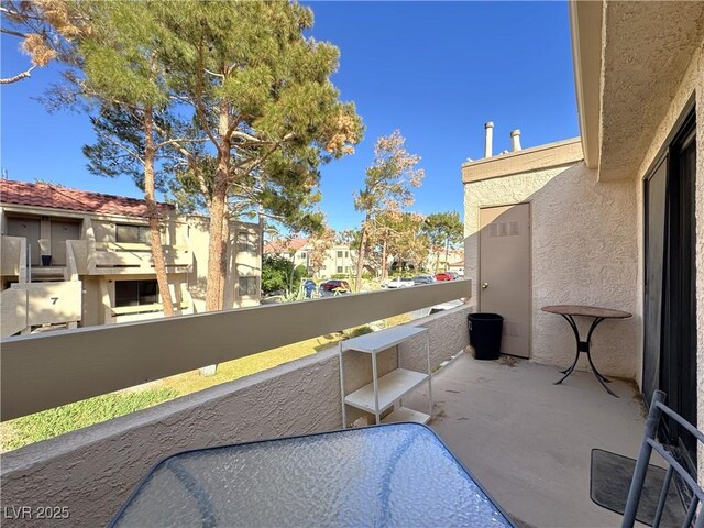 view of patio featuring a balcony