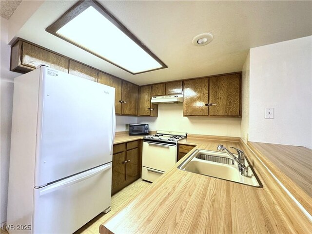 kitchen with sink and white appliances