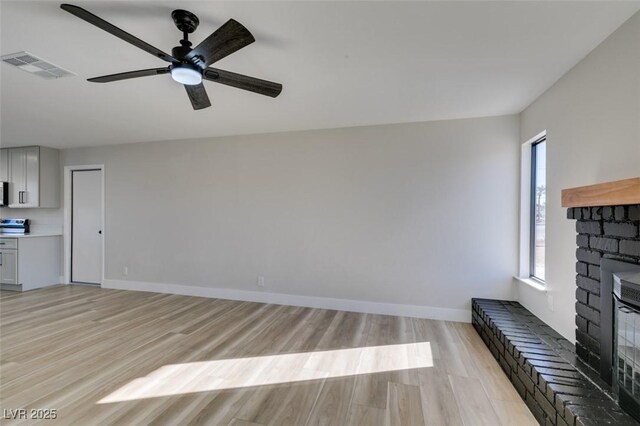 unfurnished living room with ceiling fan and light hardwood / wood-style floors