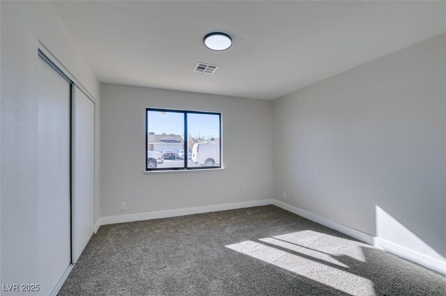 unfurnished bedroom featuring a closet and carpet flooring