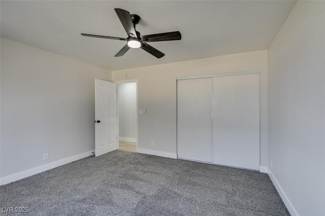 unfurnished bedroom featuring ceiling fan, a closet, and carpet flooring