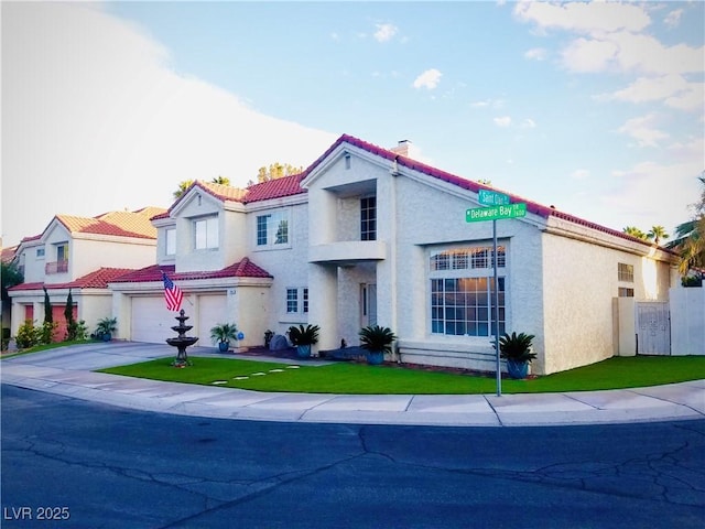 mediterranean / spanish-style home with a garage