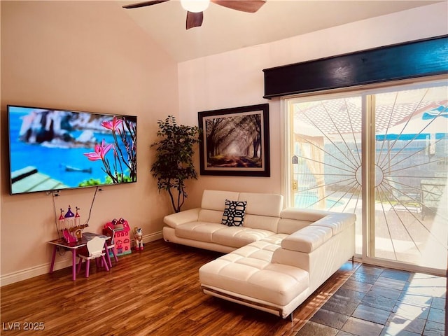 living room featuring vaulted ceiling, ceiling fan, and dark wood-type flooring