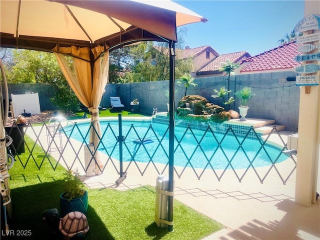 view of swimming pool featuring a lawn and a gazebo