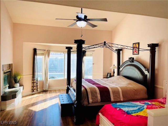 bedroom with lofted ceiling, ceiling fan, and hardwood / wood-style floors