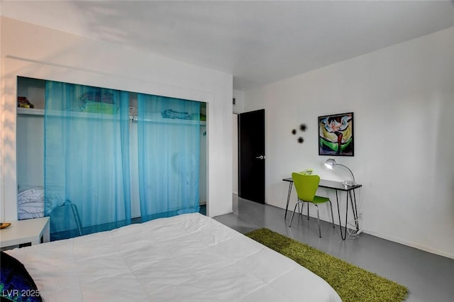 bedroom featuring concrete flooring