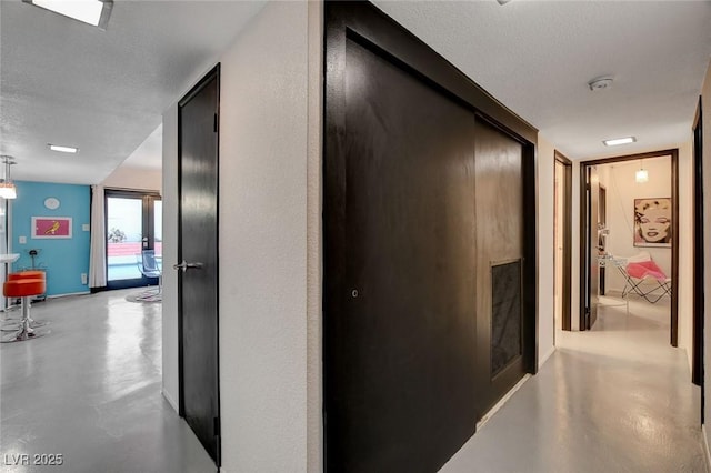 hallway featuring a textured ceiling