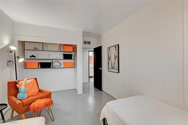 bedroom featuring concrete floors