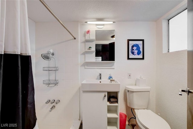 bathroom featuring sink, a textured ceiling, toilet, and walk in shower