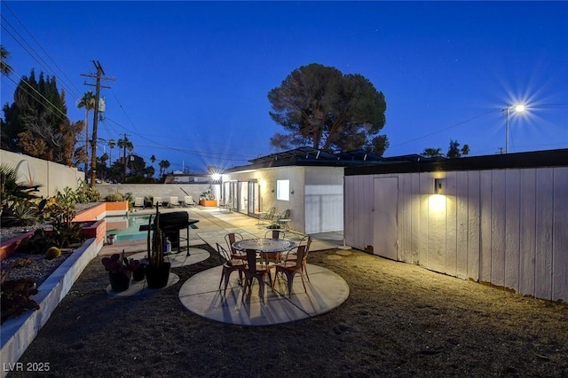 view of patio featuring a storage unit and a fenced in pool