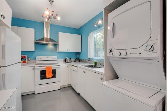 kitchen with white cabinetry, white appliances, wall chimney range hood, stacked washing maching and dryer, and sink