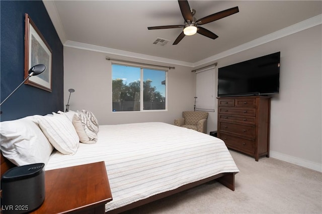 carpeted bedroom featuring ceiling fan and crown molding