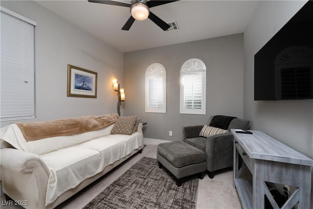 living room with ceiling fan and light carpet