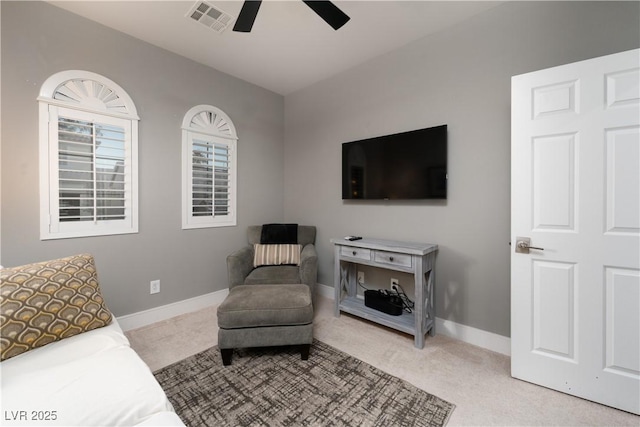 carpeted living room featuring ceiling fan