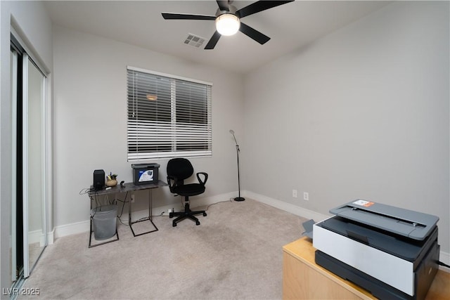 office space with ceiling fan and light colored carpet