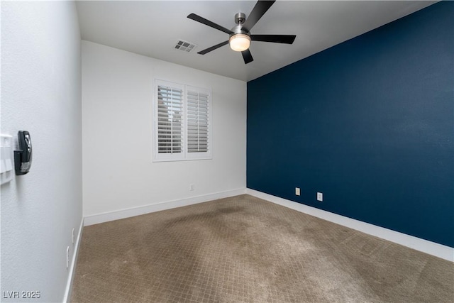 unfurnished room featuring ceiling fan and carpet