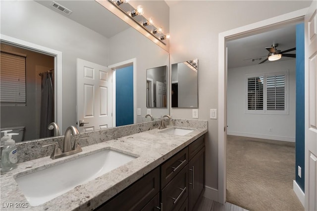 bathroom featuring ceiling fan, vanity, and toilet