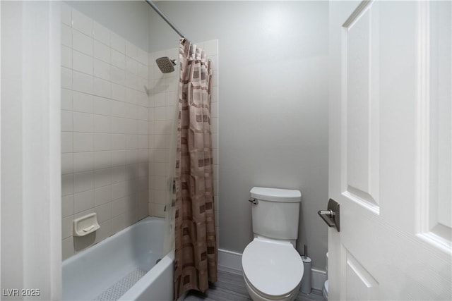 bathroom with toilet and shower / bathtub combination with curtain