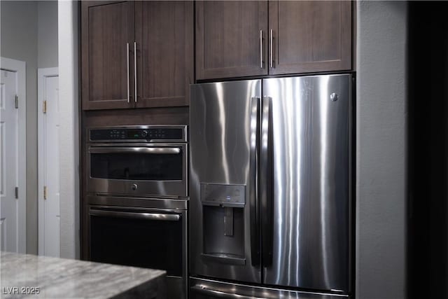 kitchen with appliances with stainless steel finishes and dark brown cabinets