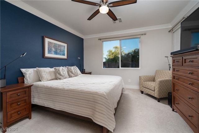 carpeted bedroom with ceiling fan and ornamental molding