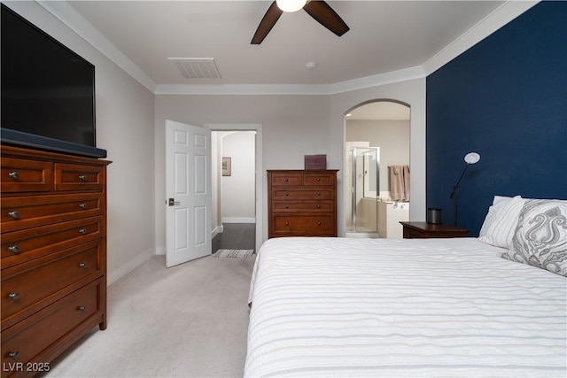 bedroom featuring ensuite bathroom, ceiling fan, light carpet, and ornamental molding