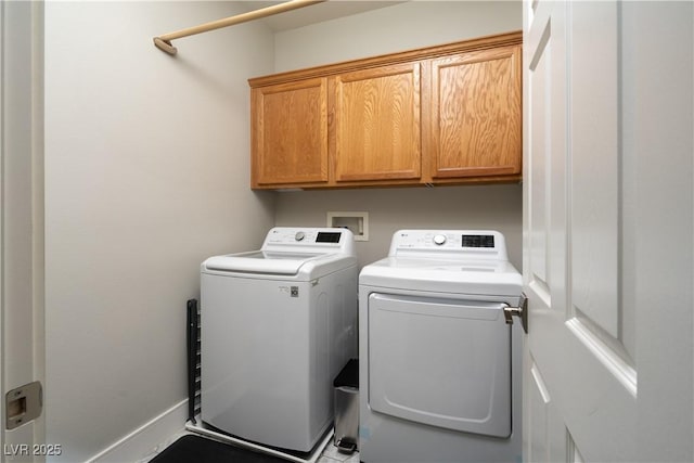 laundry area featuring cabinets and washer and clothes dryer