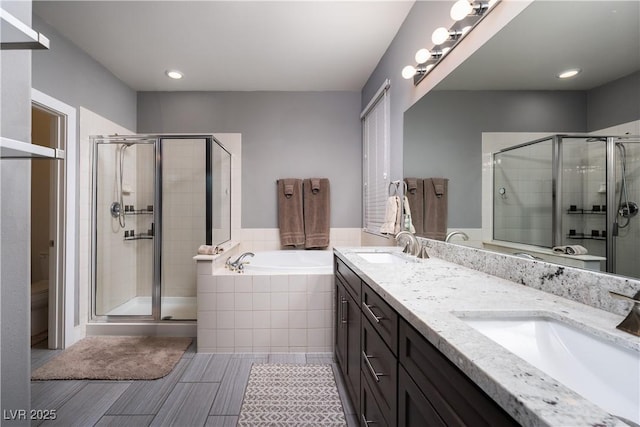 full bathroom with toilet, vanity, and shower with separate bathtub