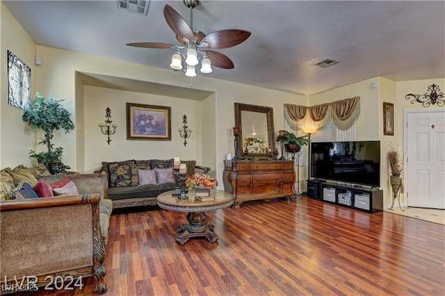 living room featuring ceiling fan and hardwood / wood-style floors