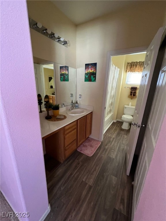 bathroom featuring a shower with curtain, hardwood / wood-style flooring, toilet, and vanity