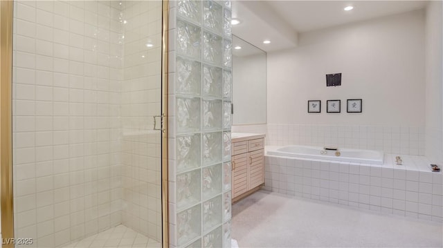 bathroom with vanity and separate shower and tub