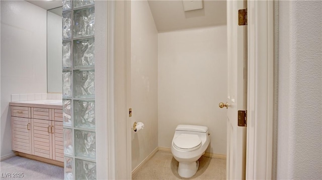 bathroom with toilet and vanity