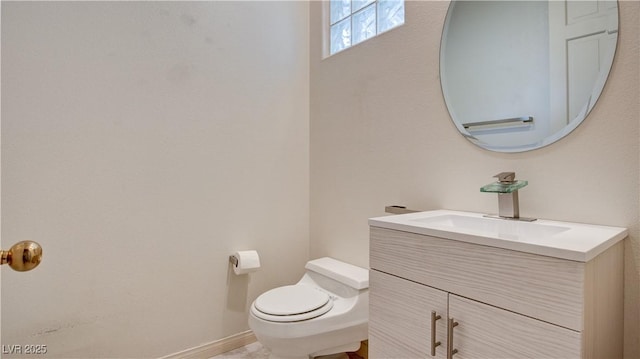 bathroom with toilet and vanity