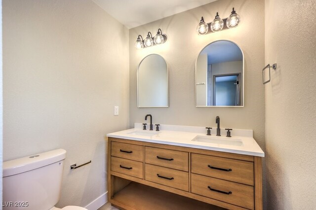 bathroom featuring toilet and vanity