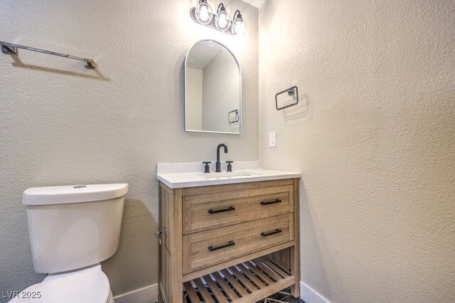 bathroom featuring toilet and vanity